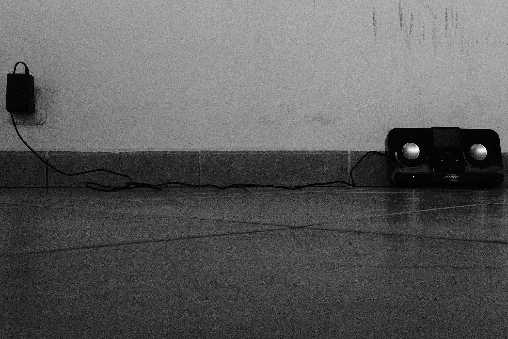 A photo of a speaker leaning against a wall
