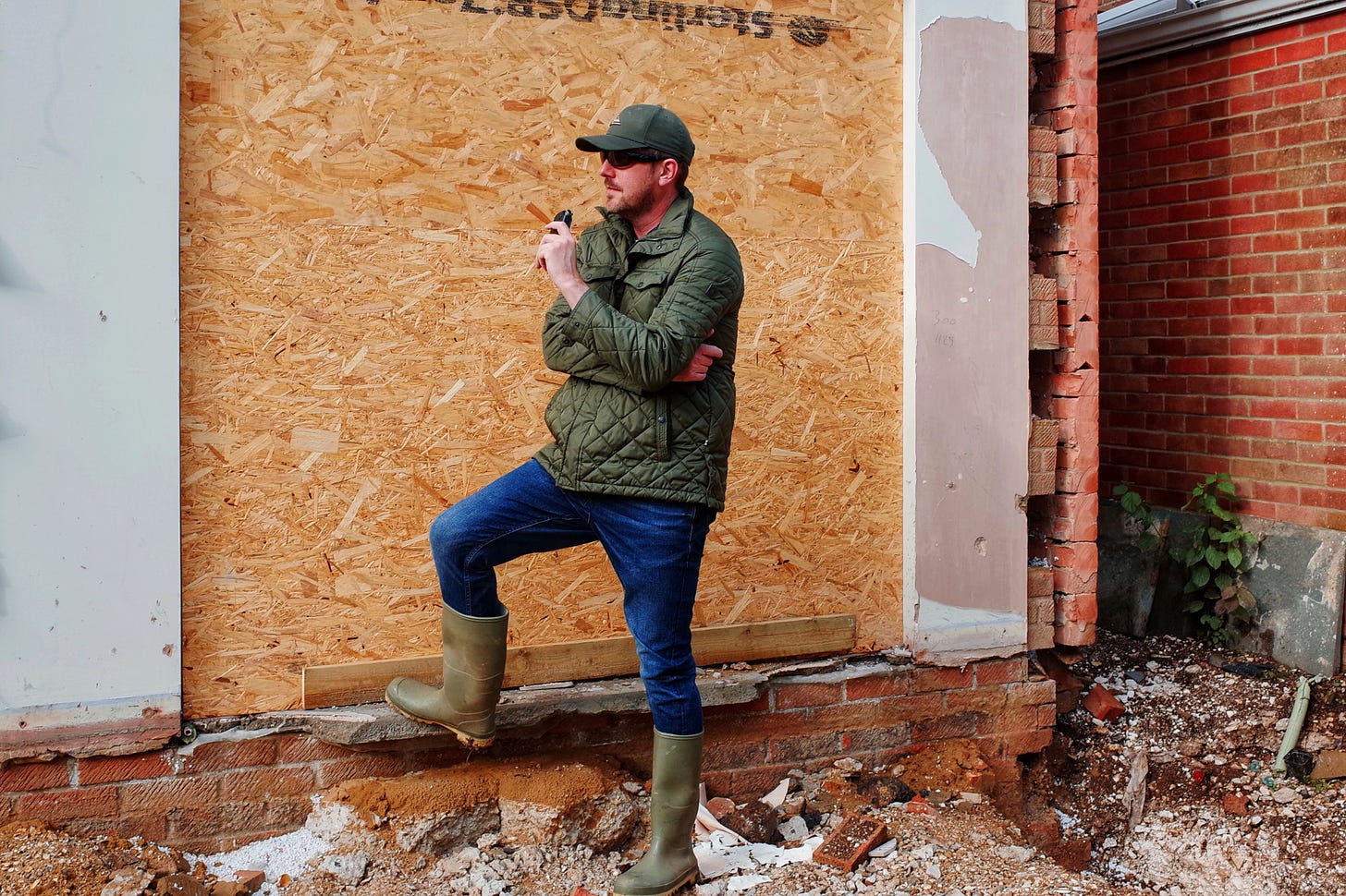 Rob Lambert posing outside a building site