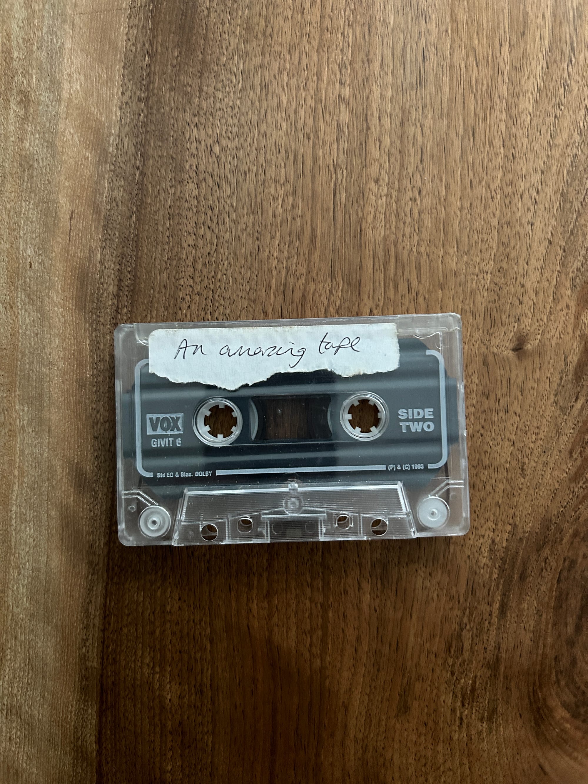 An image of an old cassette tape with the words "amazing tape" as the label