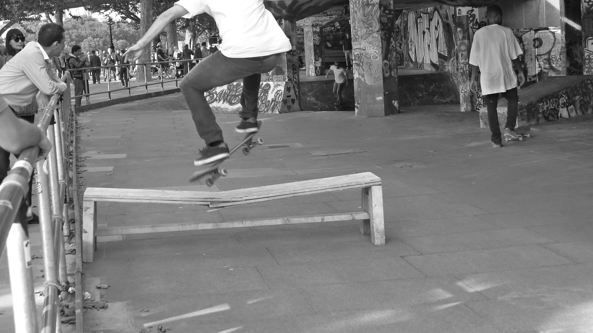 An image of a skateboarder jumping over a bench in London
