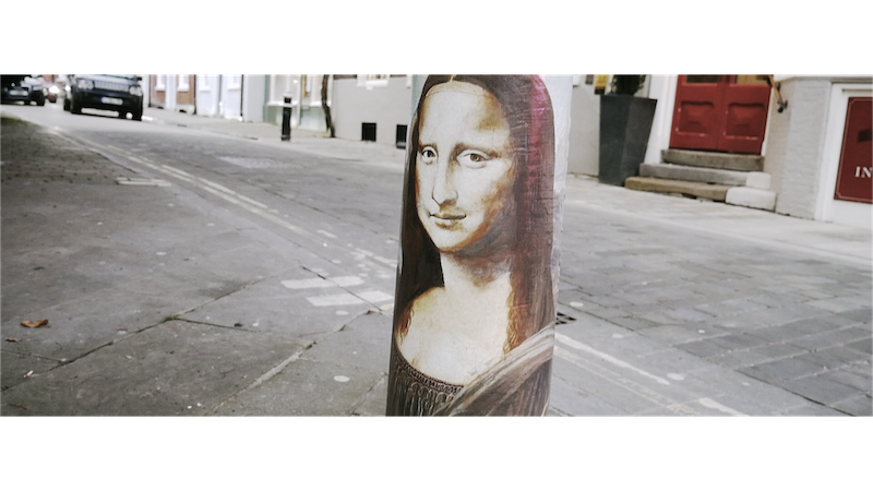 A bollard with the Mona Lisa imprinted on it