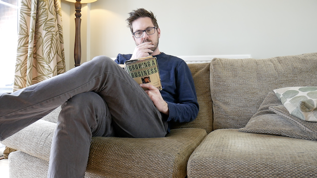 A photo of Rob Lambert reading Growing a Business by Paul Hawken
