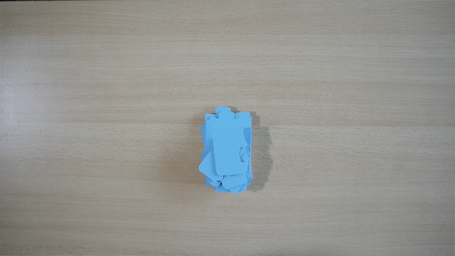 Puzzle pieces stacked into a tower.