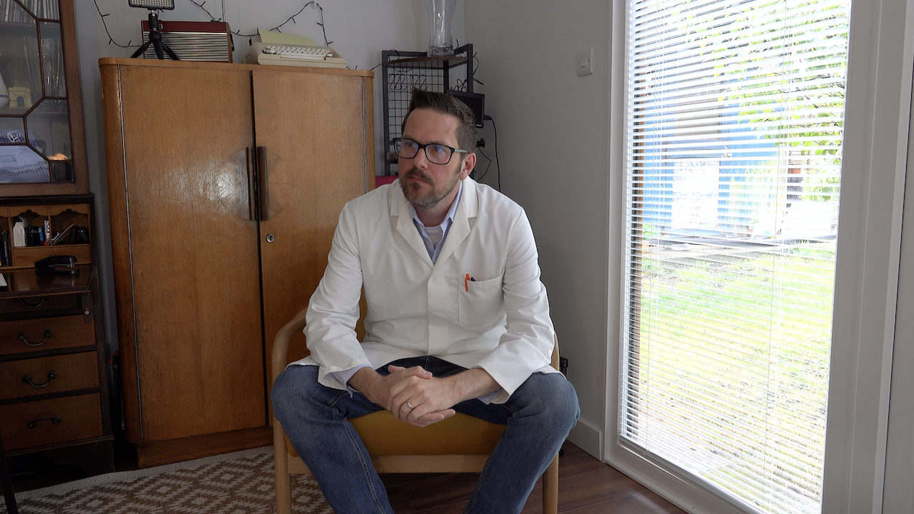 A photo of Rob Lambert in his science coat ready for study time